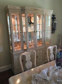 Beautiful blonde colored lighted hutch with glass shelves. The hutch matches the dining room table. It is part of the Dining Room Set that includes the lighted hutch, dining room table, 6 side chairs, and 2 arm chairs. Price for the whole set: $1,500