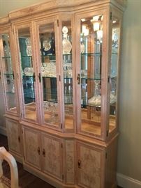 Beautiful blond color lighted hutch with glass shelves. One piece in the dining room set. Corinthians by Heritage. Price: $1,500 (includes dining room table, 6 side chairs, and 2 arm chairs)
