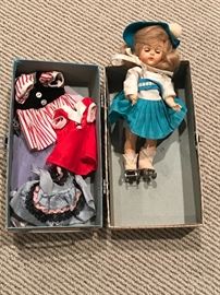 Vintage doll with roller skates. Clothes and case. 
