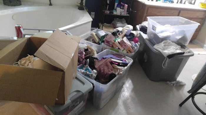 Lots of containers full of new bras panties and shapewear