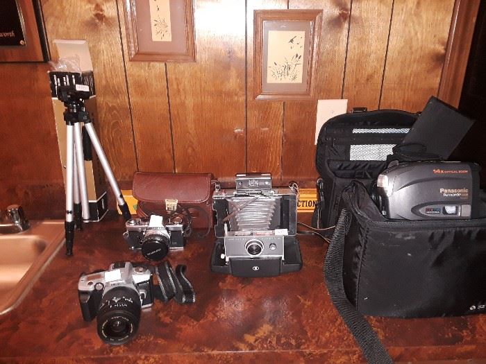 35mm cameras, vintage  polaroid, video tape camera, tripod, vintage projection screen