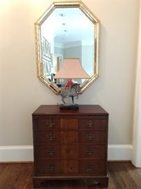 Vintage 4-Drawer banded mahogany chest, octagonal wall mirror, with Tang Dynasty bronze table lamp.