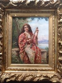 Early-mid 20th cent. Orientalist oil on canvas depicting  beauty in the Ottoman dress playing a lute on a balcony. Artist signed, 14.25"h x 11.25"w overall dimensions including the frame, 22.5" x 37.5" x 2.5"d.