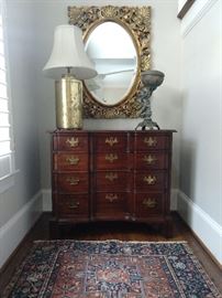 Vintage Kling 4-drawer mahogany chest, vintage metal putti, gold porcelain table lamp and gold gilt wood wall mirror, with beveled glass.