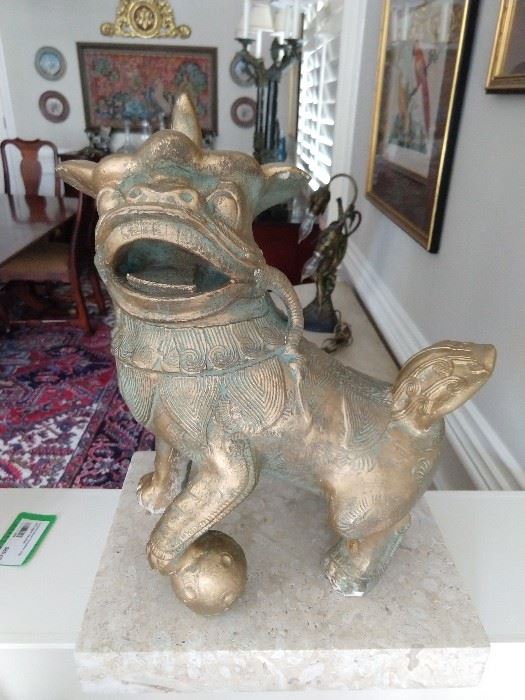 One of a pair of unusual Asian foo dogs, on a limestone base. 