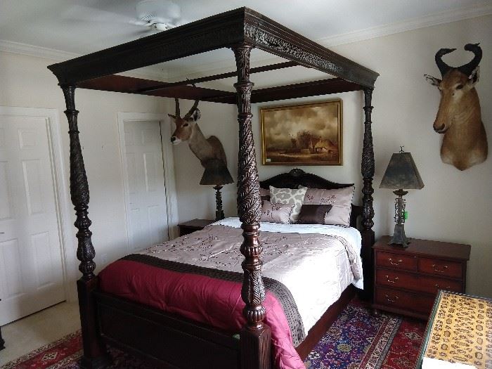 A page right out of Elvis' Graceland - The Jungle Room! Yes, don't bother knocking of you hear the taxidermy snorting! Chinese cherry four poster bed, with canopy (mosquito netting optional)