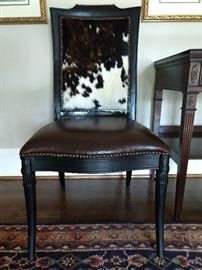 One of a pair of leather/cowhide upholstered mahogany side chairs. 