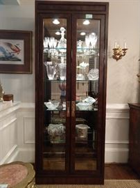 One of a PAIR of Drexel Heritage Mahogany lighted curio cabinets, wit mirrored back and three beveled glass sides.