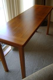 This is a solid teak side table/couch table/console table  made in Denmark measuring 51 inches wide by 16 deep and 26 tall.  Perfect condition!