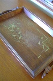 Unusual teak serving tray with cut inlaid graphics.