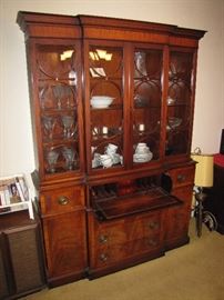 This looks like a china cabinet, and that is how it is being used, but it is actually a Secretary's Desk.  Note the drop-down front panel, forming the desktop.