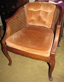 This lovely wood and rattan chair is available for sale.