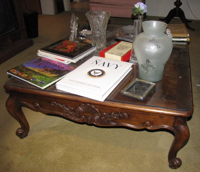 The coffee table, and associated items atop, are for sale.