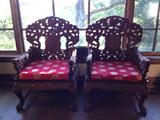 Carved Chinese chairs have dragon arm rests. Fine detail.