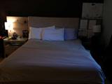 Queen size bed with two night stands, wood and upholstry on the headboard