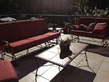 Cast iron outdoor seating set. Couch, love seat, chair with ottoman, endtable and coffe able