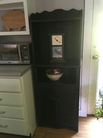 Vintage black kitchen cupboard has great storage.  