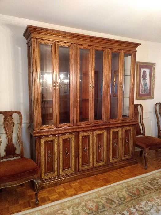 China cabinet is lighted in each separate section. Measures 76"W x 19" D x 87.25 " H
French influence in the painted design.
