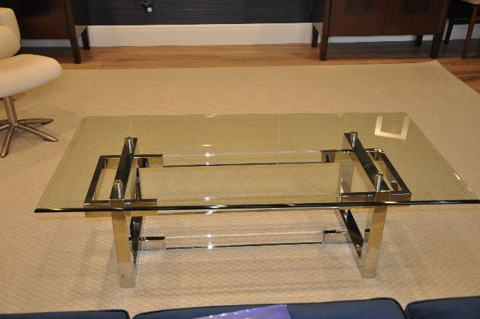 Glass, chrome and acrylic coffee table; less than one year old purchased from Gorman's for $1,875; 56" x 28" x 17"; it will present your nicest coffee table books with style for $1,200!