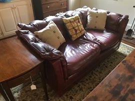 Great burgundy naugahyde sofa with pembroke end table. (Looks like leather!)