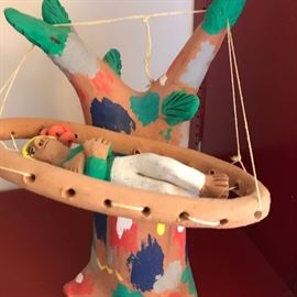 Part of a great collection of painted clay figures. This one is enjoying the hammock.