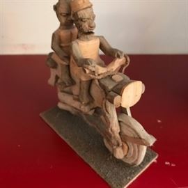 Wooden motorcyclist and passenger.