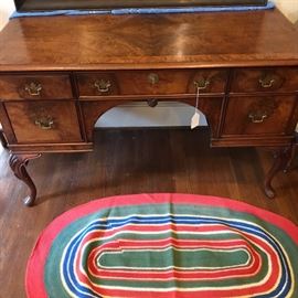 Great desk with a colorful hooked rug.