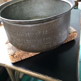 Large Asian pot sitting on a large vintage piece of cork.