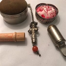 Antique needle cashes and pin cushions.