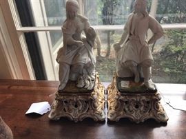 Pair of antique statues that have been drilled for lamps. Male has slight damage to base.