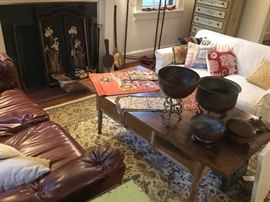 Living room with a collection of Asian copper and brass pots.