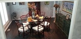 Oval glass dining room table supported by 2 iron balustrades (1800's) from London.  Six solid cherry chairs. Mahogany breakfront.  Emerald sideboard. Pair of alabaster fern stands. Artwork.
