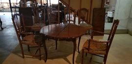 Italian country table with 2 expandable leaves & 6 rush chairs.