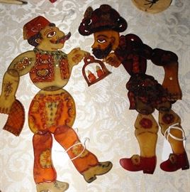TURKISH SHADOW THEATRE REAL PUPPETS HACIVAT - KARAGOZ. Shadow theatre puppets are colored and semi-transparent, with jointed limbs. During the show light from a lamp behind the stage reflects their images onto a muslin curtain. The puppets are worked by horizontal rods at right angle by the puppeteer. Made of animal skin.