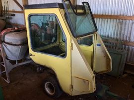 Enclosed cab for John Deere 318 lawn tractor. Add this along with the snow blower to the 318. The cab sits on a cart to easily move it around.