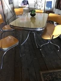 The yellow dinette set of your dreams! The table is in excellent vintage condition, with a removable leaf. The 4 chairs and the curved bench have been reupholstered, and have no rips or tears.