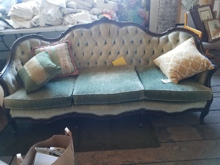 Gorgeous camel backed, carved wood victorian style sofa. Velvet upholstery