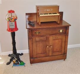 Reproduction gumball machine. Mixed wood washstand.