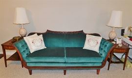 Beautiful Empire style sofa recovered in a beautiful emerald green velvety fabric. Pair of leather top end tables. Pair of vintage ceramic lamps.