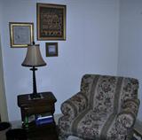 Over-Stuffed Chair, 1 Drawer pine stand, lamps & hand done samplers.