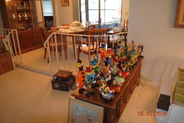 Multiple Venetian and Murano hand-blown glass clowns, some of which are decanters