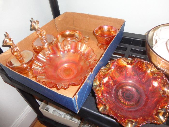 Many Carnival glass items in the orange to amber coloration.