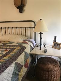 Metal frame bed, vintage quilt, lidded basket, wrought iron lamps and accessories 