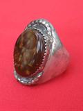Large sterling man's ring with interesting 1" brown stone, tested silver, size 10, weighs 20.3 grams