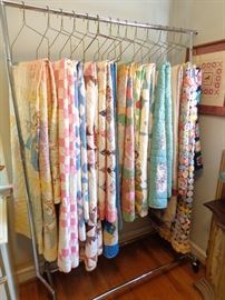 Vintage and antique hand-sewn quilts, including two yoyo quilt tops. 
