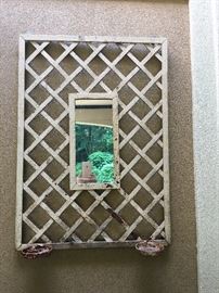 Rustic lattice-framed mirror with two stands for candles or plants