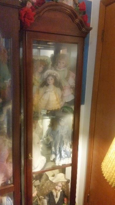 smaller curio cabinet with dolls