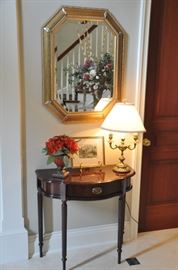 Petite cherry one drawer demilune table shown with a double candlestick antique brass table lamp and a wonderful antique petite etching