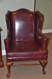 One of the two Burgundy and black leather wingback chairs with nailhead design available 32"w 42"h x 25"d 