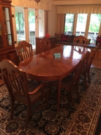 Beautiful Bassett dinning room table with 6 chairs and table pads. Huge area rug